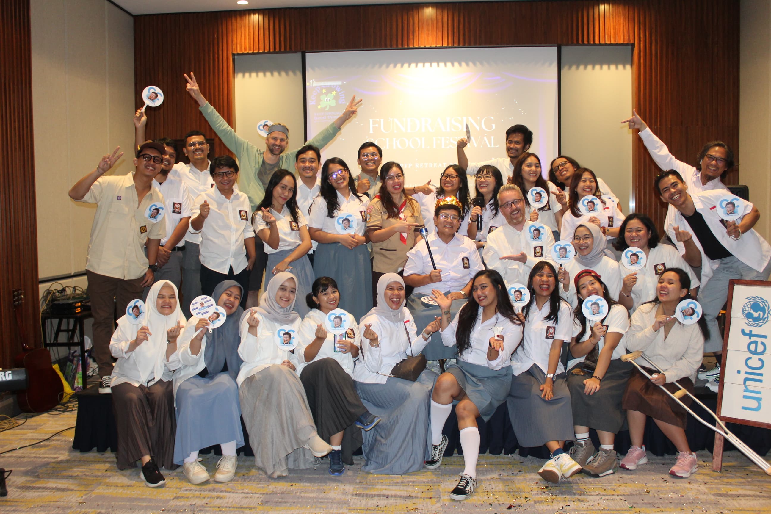 UNICEF Donor Love Club group portrait on stage with event branding